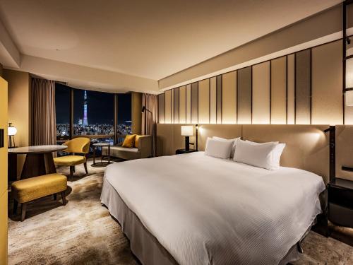 a hotel room with a large bed and a table at Asakusa View Hotel in Tokyo