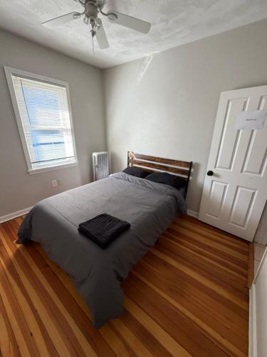 a bedroom with a bed and a ceiling fan at Providence Cozy Stays in Providence