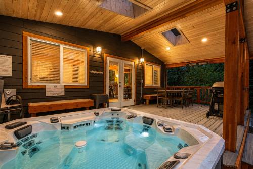a jacuzzi tub in the middle of a house at Compass Cabin by NW Comfy Cabins in Leavenworth