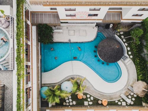 an overhead view of a pool at a resort at Roomates Beach Hostel Canggu by Ini Vie Hospitality in Canggu