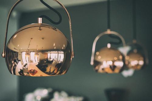 two lights hanging in a room with a green wall at Hara Hotel in Chalkida