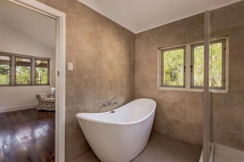 a large bathroom with a tub and windows at Lockn Heart Homestead in Quindalup