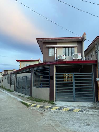 a building with two garage doors on a street at Casa Lumina in Tinuric