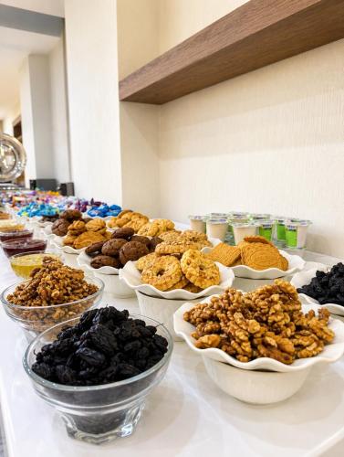 a table topped with bowls of different types of food at Firdavsi Hotel in Dushanbe