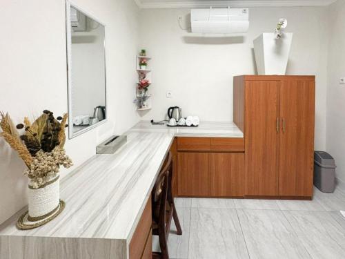 a kitchen with a wooden counter and a sink at The Lavana Pondok JegegBagus near Pandawa Beach in Ungasan