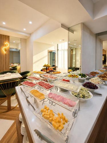 a buffet of food on a long table at Firdavsi Hotel in Dushanbe