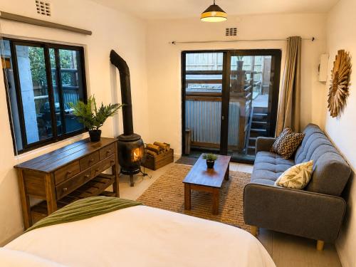 a living room with a couch and a table at Kaaimans River Rustic Views in Wilderness
