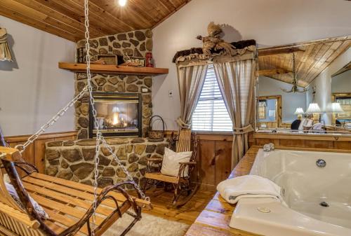 a living room with a tub and a fireplace at Barefoot Dreams in Sevierville