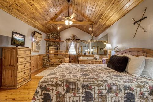 a bedroom with a bed and a wooden ceiling at Barefoot Dreams in Sevierville