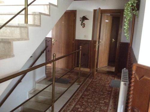 a hallway with a staircase with a stair railing at Györgyi Haus in Bük