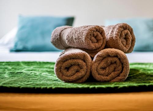 a pile of towels sitting on top of a bed at Ryckevelde in Damme