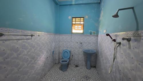 a bathroom with a toilet and a window at Iris Grand Hotel in Nittambuwa