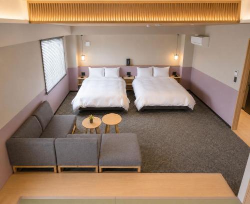 a hotel room with two beds and a couch at シーザー祇園CaesarGion in Kyoto