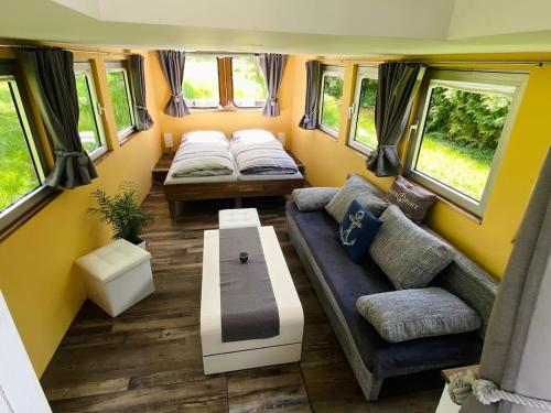 a living room in a tiny house with a couch and a table at Black Pearl in Pölitz