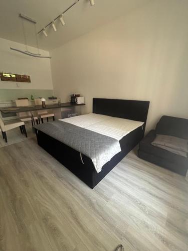 a large bedroom with a bed and a table at Freedom apartman in Zamárdi