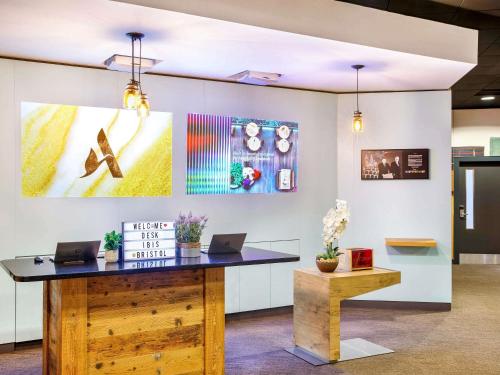 an office with a desk with two laptops on it at ibis Bristol Centre in Bristol
