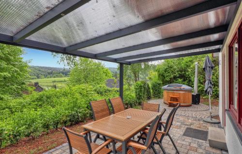 a patio with a table and chairs and a grill at Maier Kirchheim in Kemmerode