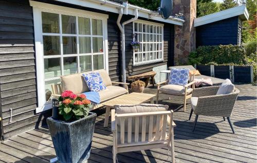 a group of chairs and a table on a porch at Gorgeous Home In Hundested With Wifi in Hundested