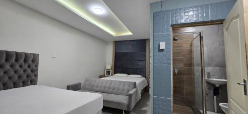 a small bedroom with two beds and a shower at Co operville in Potchefstroom