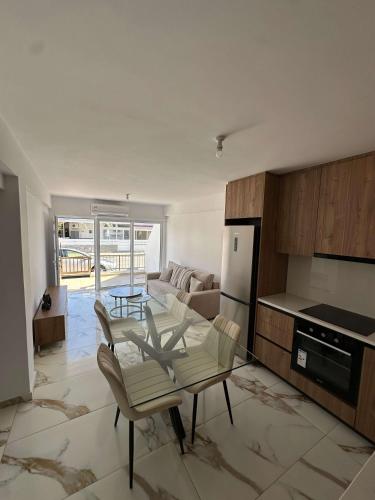 a kitchen and living room with a table and chairs at WHTheGroundNest in Paralimni