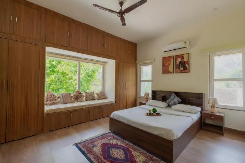 a bedroom with a large bed and a window at Hotel Elysian By G K Group Near IGI Delhi Airport in New Delhi