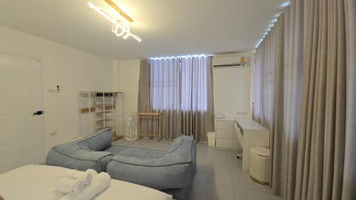 a hotel room with a bed and a bathroom at Chillax Townhome 65 in Hua Hin