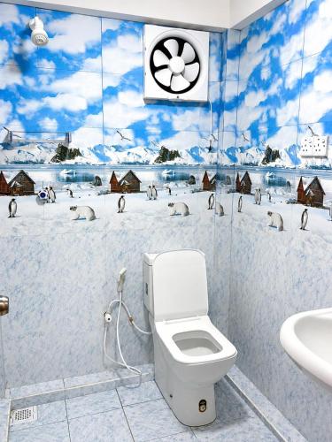 a bathroom with a toilet and a snow covered wall at DNN Brothers Villa in Jaffna