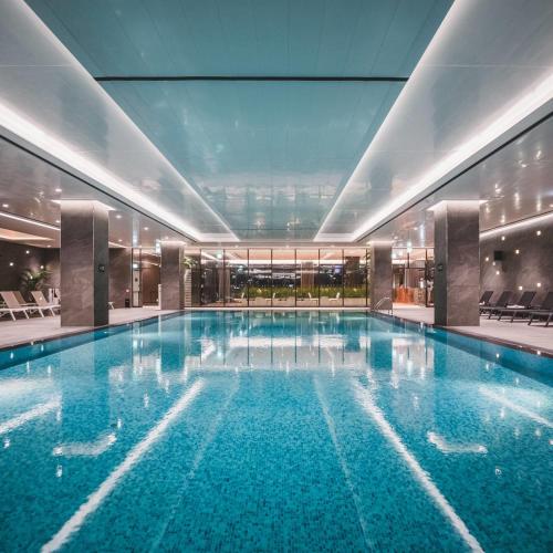 a large swimming pool in a building at DoubleTree By Hilton Seoul Pangyo in Seongnam