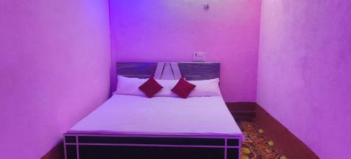 a small pink room with a bed in it at Hotel Sunrise inn in Nārdiganj