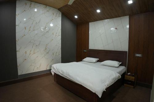 a bedroom with a large bed and a large mirror at Saanjh Private Pool Villa Jaipur in Jaipur