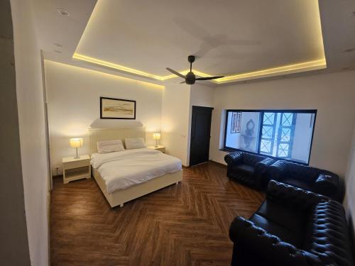a bedroom with a bed and a living room with a couch at The Terraces by 12th Avenue in Murree