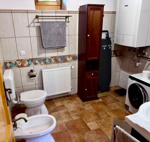 a small bathroom with a toilet and a sink at The Szigliget Residence in Szigliget