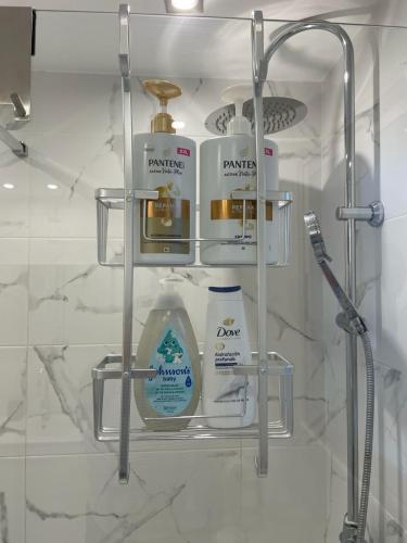a shelf in a bathroom with products on it at Anna Apartment in Altea