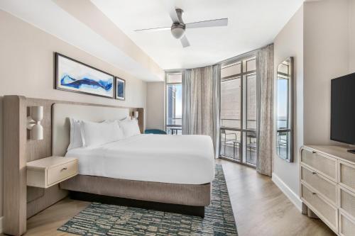 a bedroom with a bed and a tv at Hilton Grand Vacations Club Ocean 22 Myrtle Beach in Myrtle Beach
