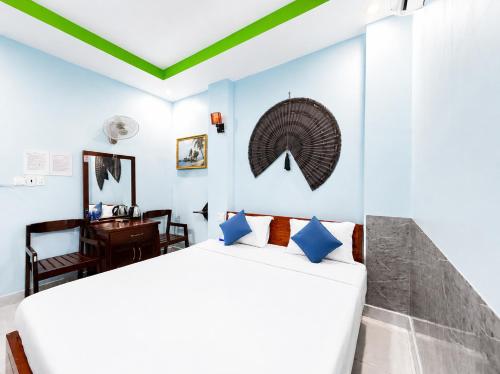 a bedroom with two beds and a desk at Palette Anh Vu Hotel Phu Quoc in Phú Quốc