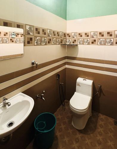 a bathroom with a toilet and a sink at Olive Homestay in Cochin