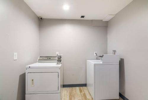 a laundry room with two washes and a stove at Quality Inn Rochester West in Rochester