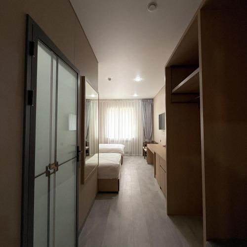 a hotel room with a bed and a mirror at AiRom Hotel in Atyrau