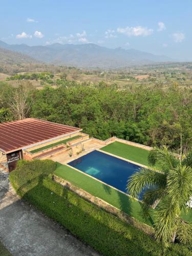 an aerial view of a house with a swimming pool at Paihappy village in Ban Thung Pong