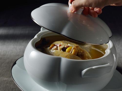 a person is holding a spoon in a bowl of soup at Grand Mayfull Taipei in Taipei