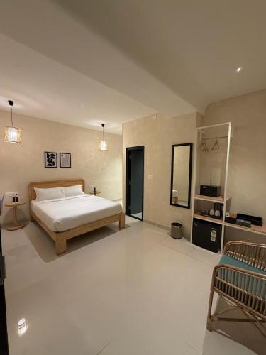 a large bedroom with a bed and a couch at NestSort Hotel in Mysore