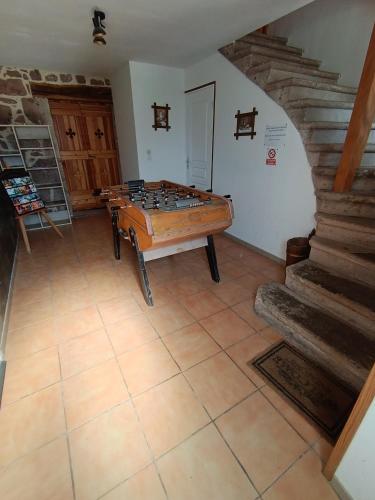 a living room with a foosball table and stairs at F5 à Montjaux in Montjaux