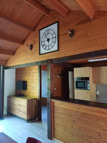 a clock on the wall of a room at chalet 282 - La Boverie in Rendeux