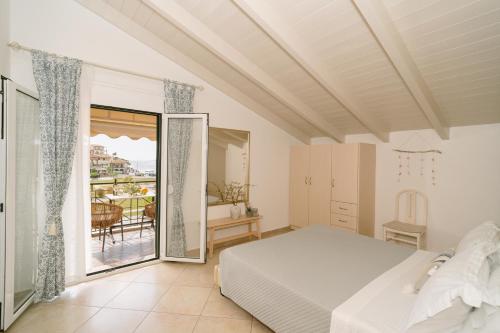 a bedroom with a bed and a balcony at Fissas Rooms in Syvota