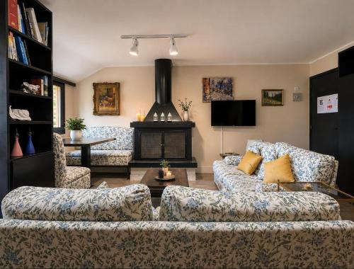 a living room with two couches and a fireplace at ComeCasa La Magdeleine 2BDR APT in La Magdeleine