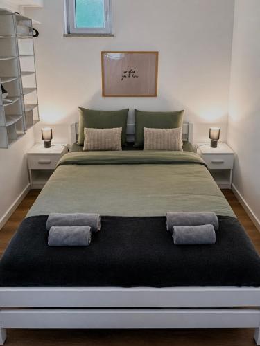 a large bed with two pillows on it in a room at Holiday home Damian - Private pool in Ðurđekovec
