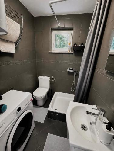 a bathroom with a sink and a toilet and a tub at Holiday home Damian - Private pool in Ðurđekovec