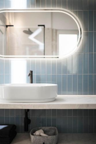 a bathroom with a sink and a mirror at Brixen City Maisonette in Bressanone