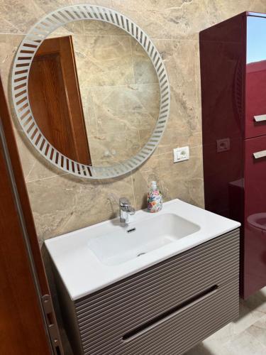 a bathroom with a sink and a mirror at Lucas&Timeea in Caransebeş