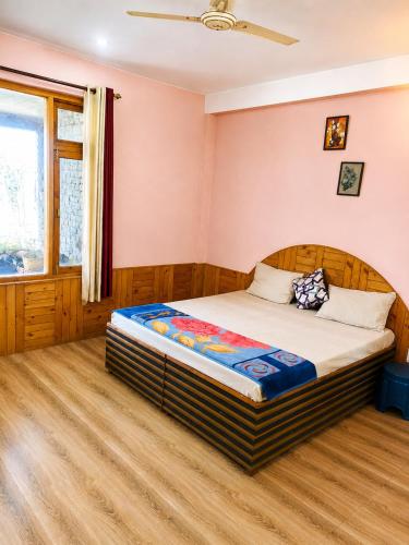 a bedroom with a bed in a room at Adarsh homestay - 1BHK in Manāli